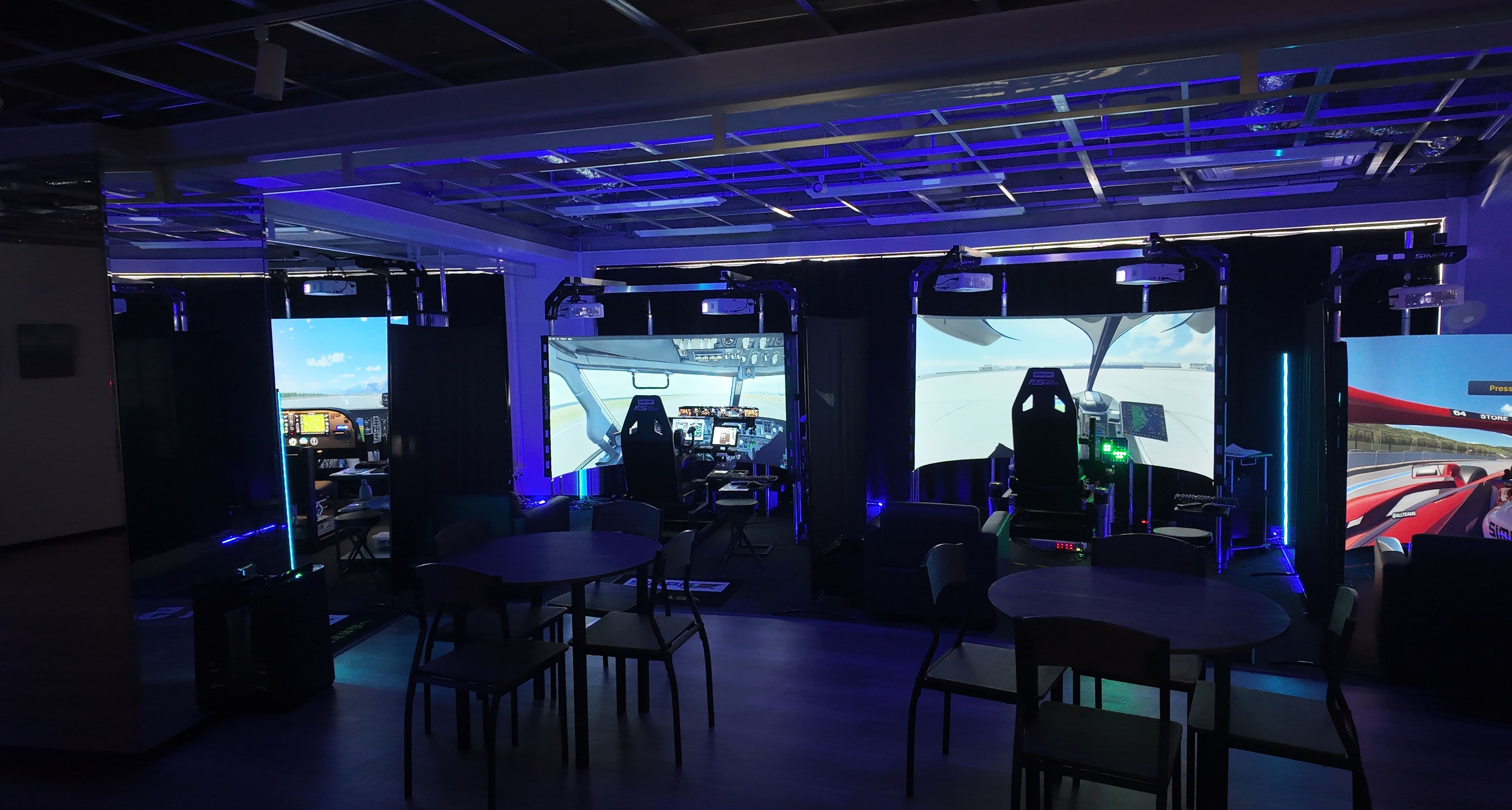 SimPit Store lounge area in Tokyo, multiple rigs running under blue ambient lighting